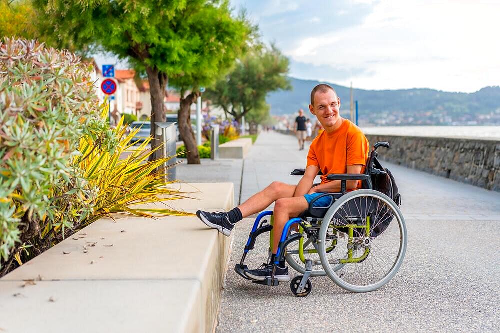 A disabled person in a wheelchair on the beach on summer vacation