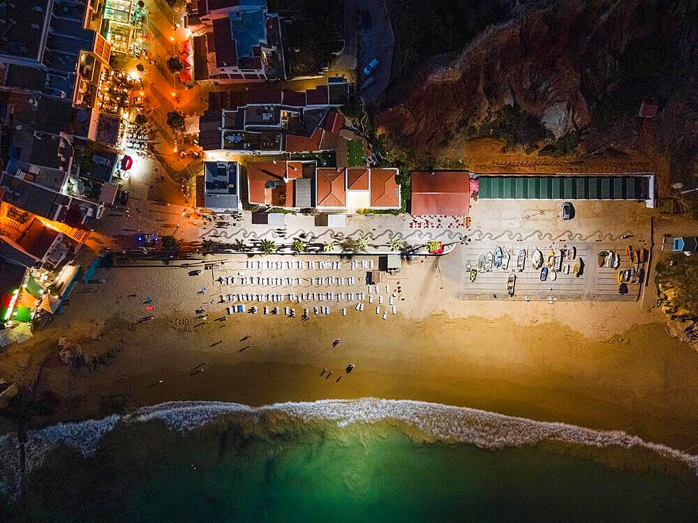 The beach of Olhos de Agua, a former fishing village in the Portuguese Algarve in the district of Faro, near the town of Albufeira, is illuminated in the evening and at night by huge floodlight masts so that beachgoers can still swim in the Atlantic after sunset. (Aerial photo taken with a drone), Algarve, Olhos de Agua, Faro, Portugal, Europe