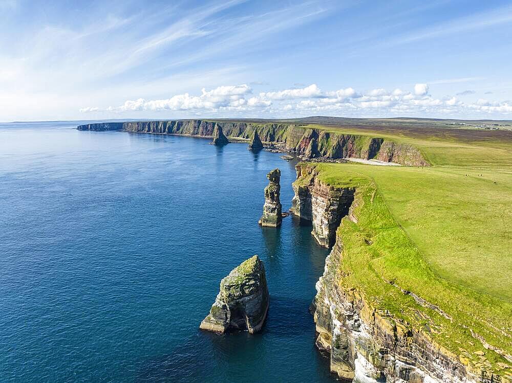 Aerial view of the rugged coastal landscape at Duncansby Head with rock tower, behind it the Duncansby Stacks, County Caithness, Scotland, Great Britain