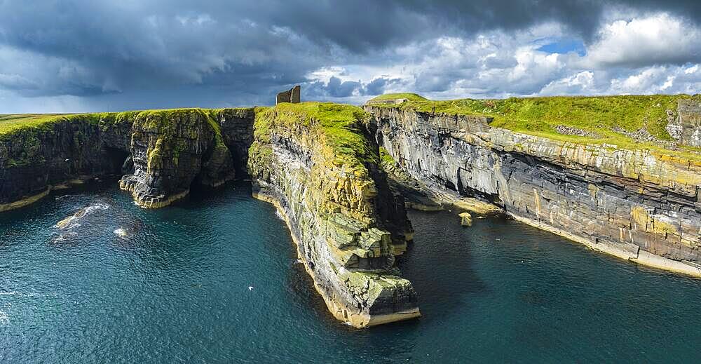 Aerial panorama of the ruined Castle of Old Wick surrounded by rugged cliffs on the North Sea coast, Wick, County Caithness, Scotland, United Kingdom, Europe