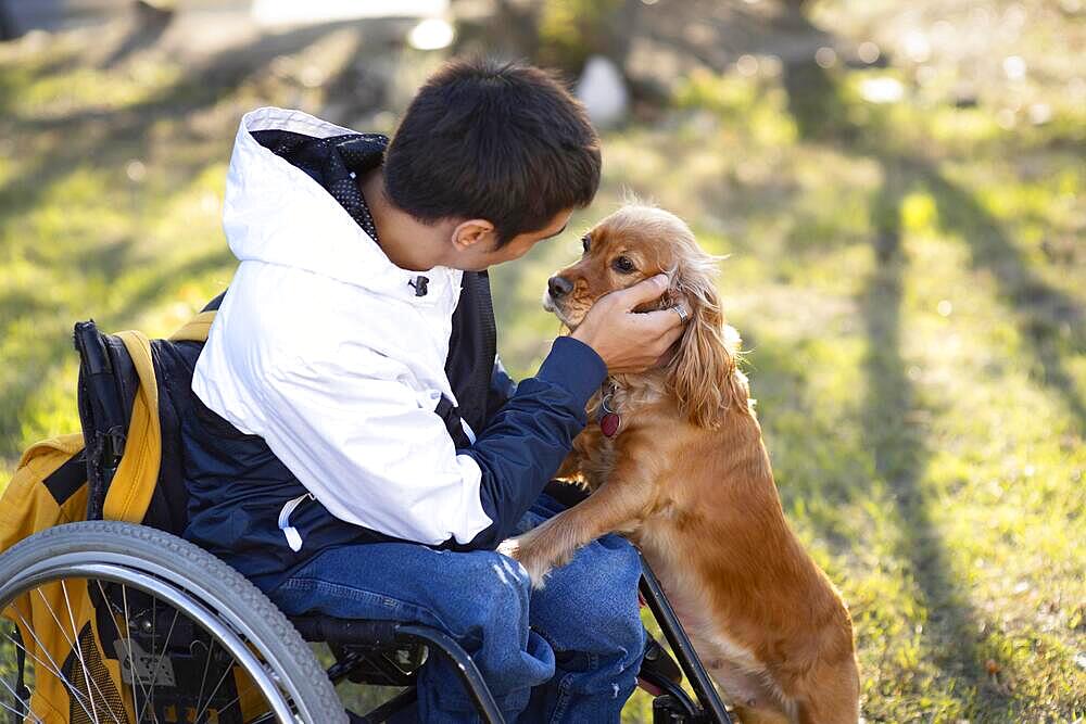 Medium shot disabled man petting dog