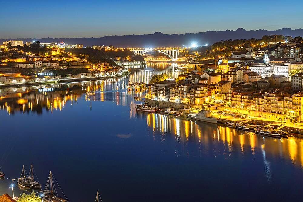 View over the river Douro to the old town of Porto and Vila Nova de Gaia at dusk, Portugal, Europe