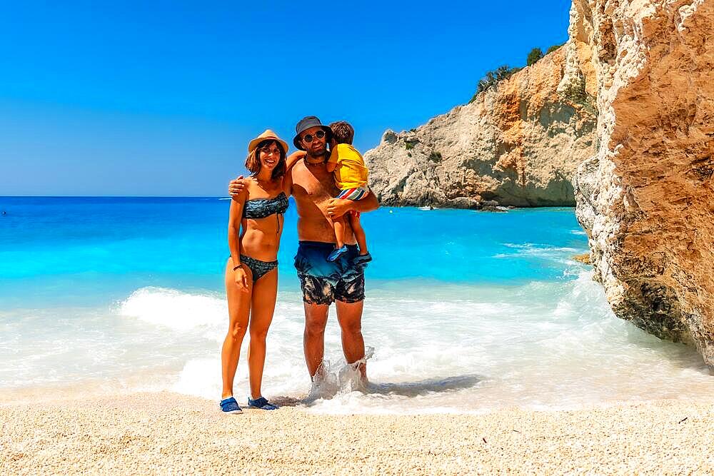 Portrait of a family having fun on Porto Katsiki beach in Lefkada island on vacation, Greece, Europe