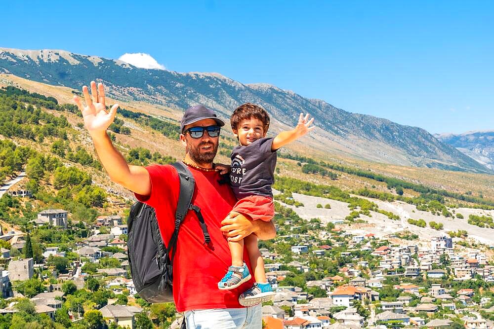 Portrait of a father with his son having fun in the Ottoman Castle Fortress of Gjirokaster or Gjirokastra. Albanian