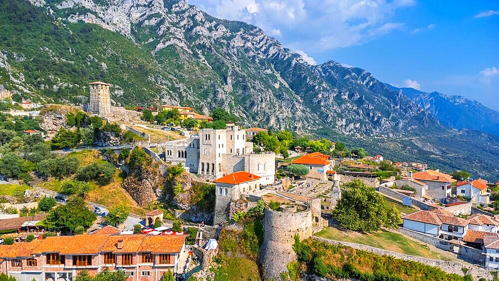 Aerial drone view of Kruje Castle and its fortress, inside the Kruje tower and museum with the mountains in the background. Albania