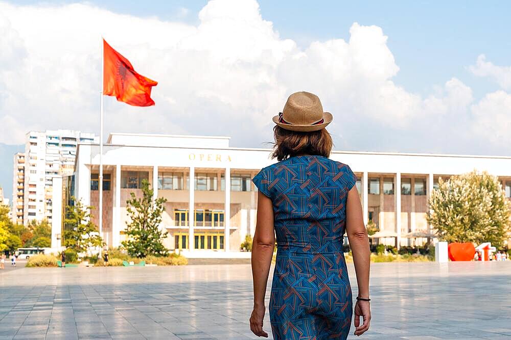 A tourist visiting the Palace of Culture or Opera in Skanderbeg Square in Tirana. Albania