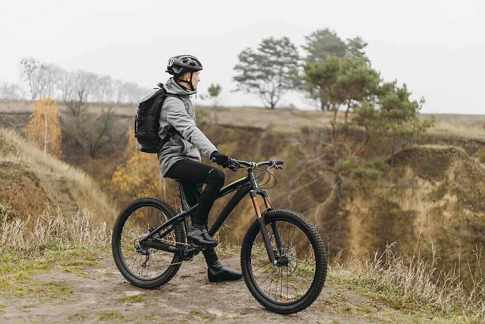 Man riding bike mountain path