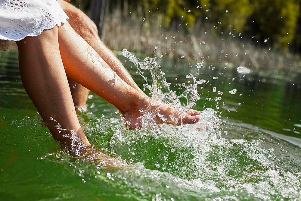 Couple playing with their feet water