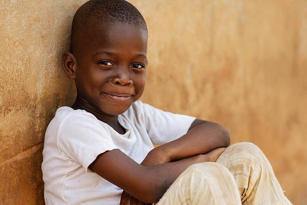 Medium shot smiley kid sitting outdoors