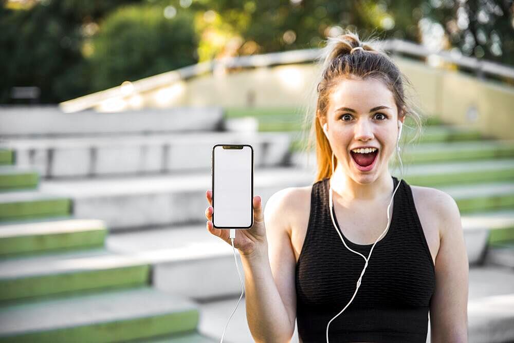 Young woman holding smartphone