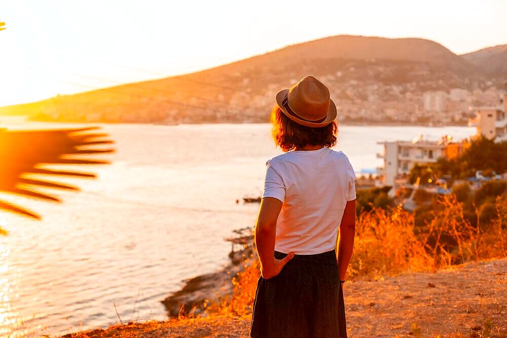 Tourist woman at Sarande or Saranda sunset in Albanian riviera enjoying summer vacation, Albania, Europe