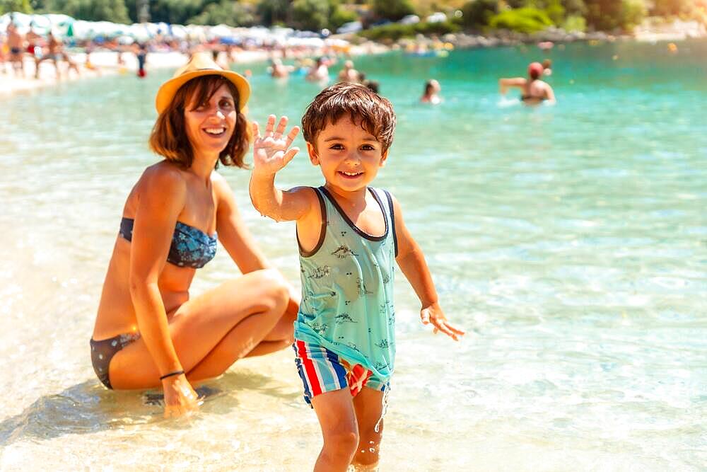 Portrait of Mother and son enjoying the summer on the beach in summer of Paralia Mikros Gialos in the south of the island of Lefkada. Greece