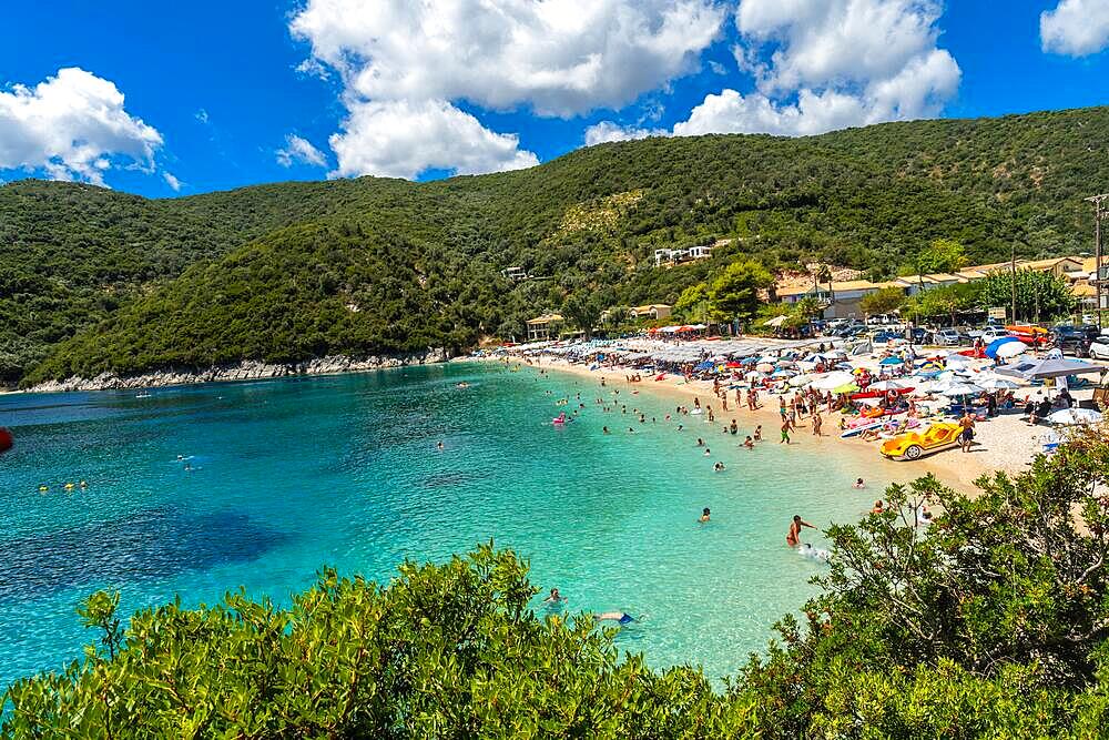 View of the beach in summer crowded with bather people at Paralia Mikros Gialos in Lefkada. Greece