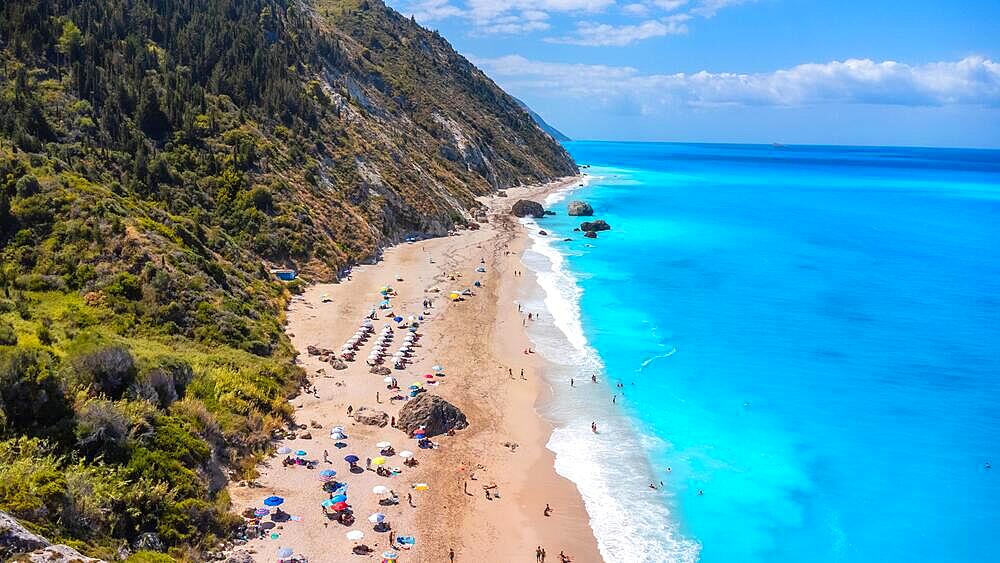 Drone shot of beautiful crystal clear turquoise and blue water at Megali Petra sandy beach in Lefkada. Greece