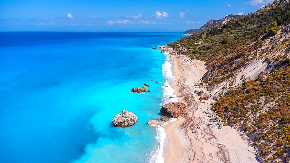 Aerial drone view on paradise sandy Megali Petra beach in Lefkada. Beautiful crystal clear turquoise and blue waters. Greece