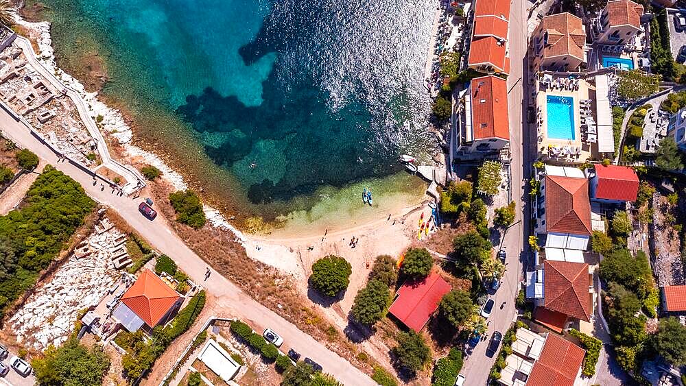 Aerial view in summer of a small beach in the port of the village of Fiskardo on the island of Kefalonia, Greece, Europe