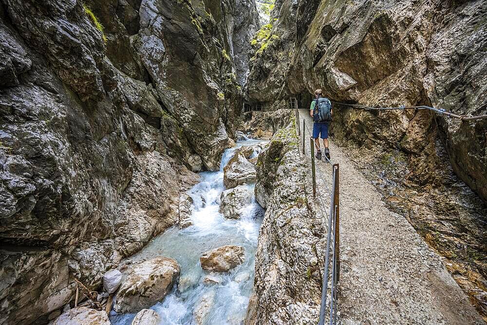 Climbers on their way through the Hoellentalklamm, narrow rock gorge with mountain stream, Wetterstein Mountains, Garmisch-Partenkirchen, Werdenfelser Land, Upper Bavaria, Bavaria, Germany, Europe