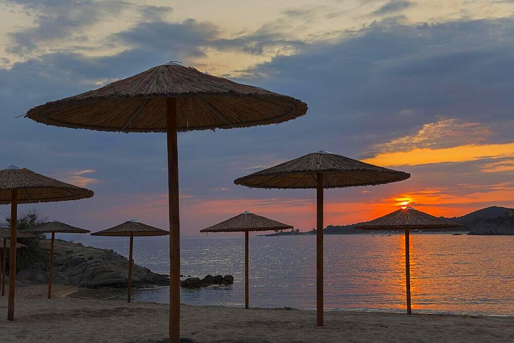 Parasols, sunset, Ema beach, Toroni, Torone, Sithonia, Halkidiki, Central Macedonia, Greece, Europe