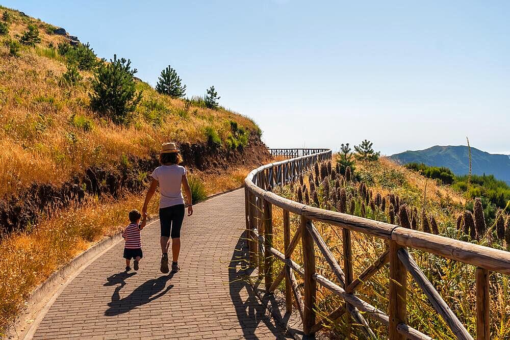 A mother walking with her son at the viewpoint of Miradouro do paredao, Madeira. Portugal