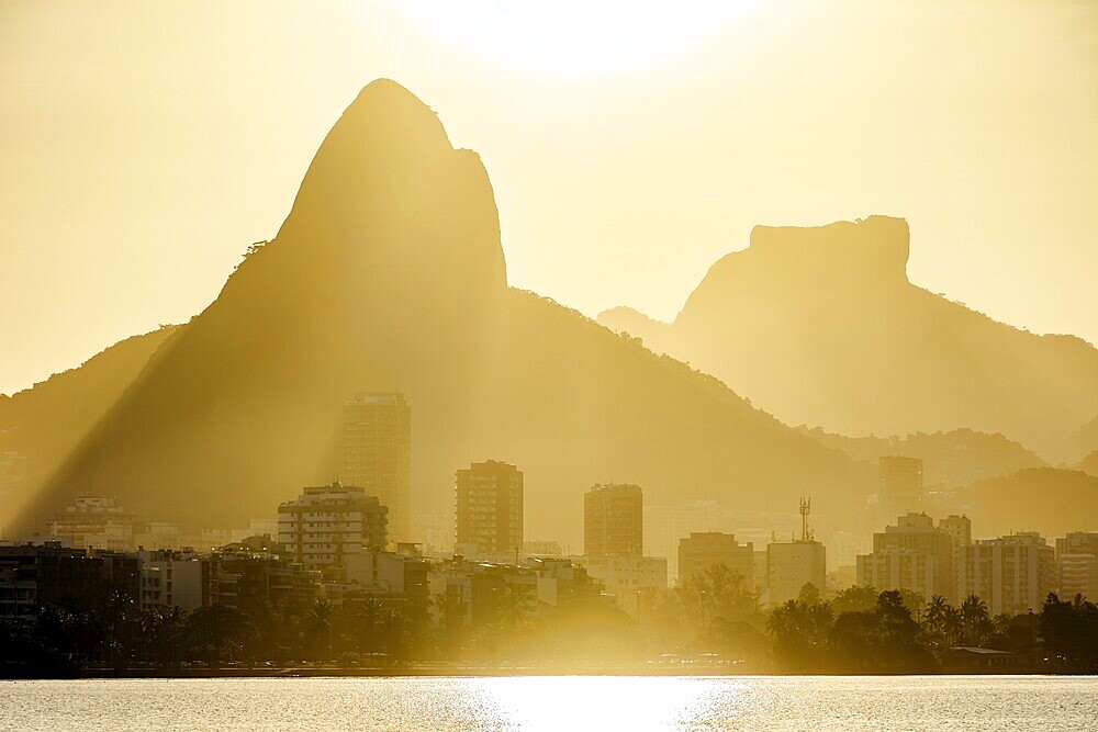 Sunset at the Rodrigo de Freitas lagoon in the city of Rio de Janeiro with the Gavea stone and Two Brothers hill, Brasil