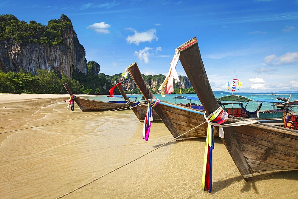 Long tail boats on tropical beach in Thailand