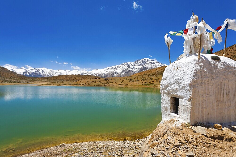 A stupa stands at the edge of a pristine mountain lake used by Buddhist pilgrims near Dhankar, Spiti Valley, Himachal Pradesh, India, Asia