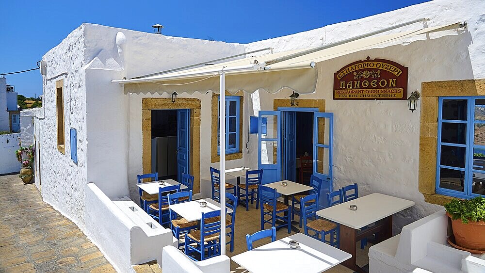 Cosy restaurant with blue chairs, white walls and Mediterranean atmosphere outdoors, Chora, Old Town, Patmos, Dodecanese, Greek Islands, Greece, Europe