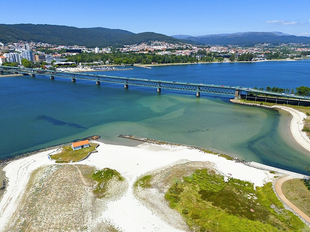 View of a coastal town with a bridge over a river flowing into the ocean, surrounded by hills and white sandy beach, aerial view, Ponte Eiffel, bridge by Gustave Eiffel, Lima River, Viana do Castelo, Portugal, Europe