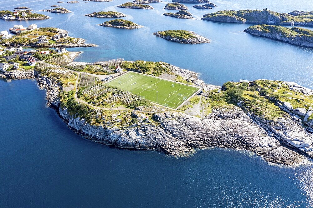 Aerial view over football stadium on rocky island, fishing village Henningsvaer, Lofoten, Norway, Europe