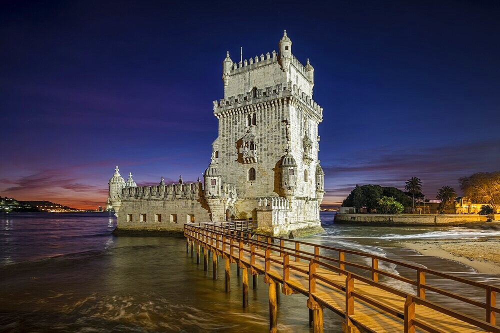 Belem Tower or Tower of St Vincent, famous tourist landmark of Lisboa and tourism attraction, on the bank of the Tagus River (Tejo) after sunset in dusk twilight with dramatic sky. Lisbon, Portugal, Europe