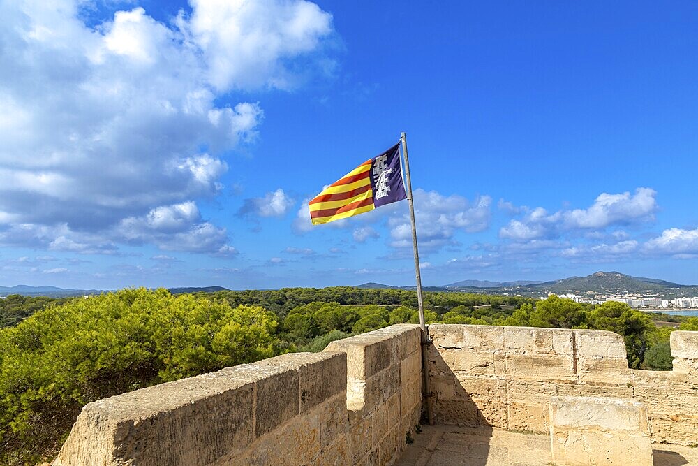 Flag of Majorca on an old defence defence tower in the Punta de n'Amer nature reserve near Cala Millor