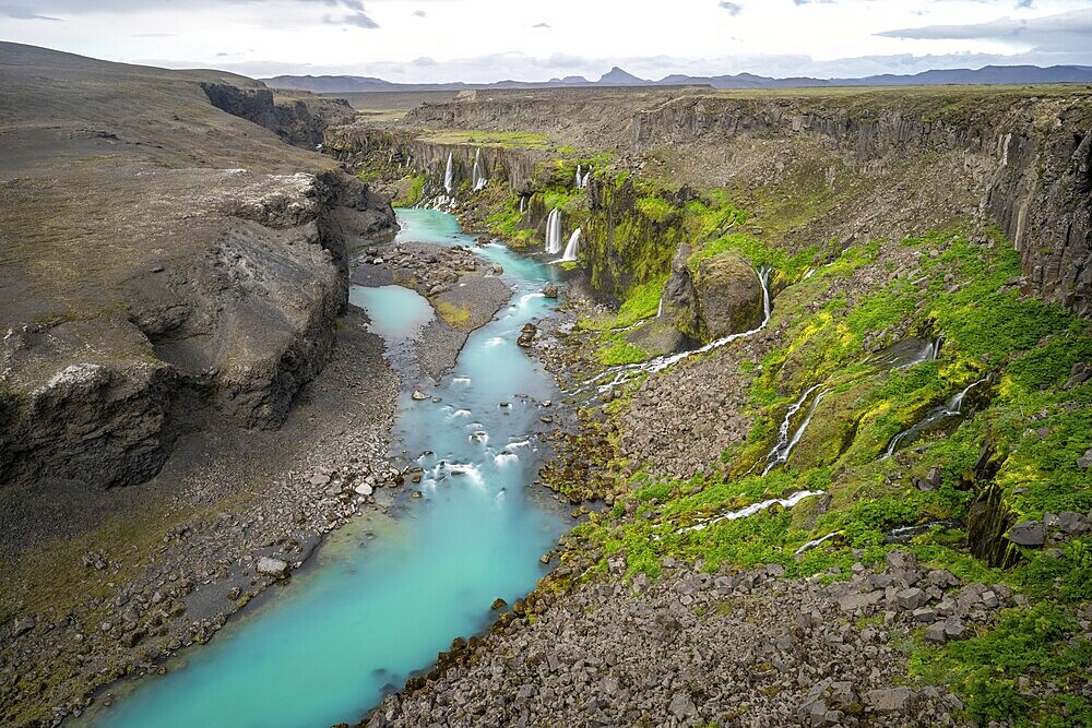 Waterfalls and a turquoise blue river flowing through a canyon, Sigöldugljúfur, long exposure, Icelandic highlands, Iceland, Europe