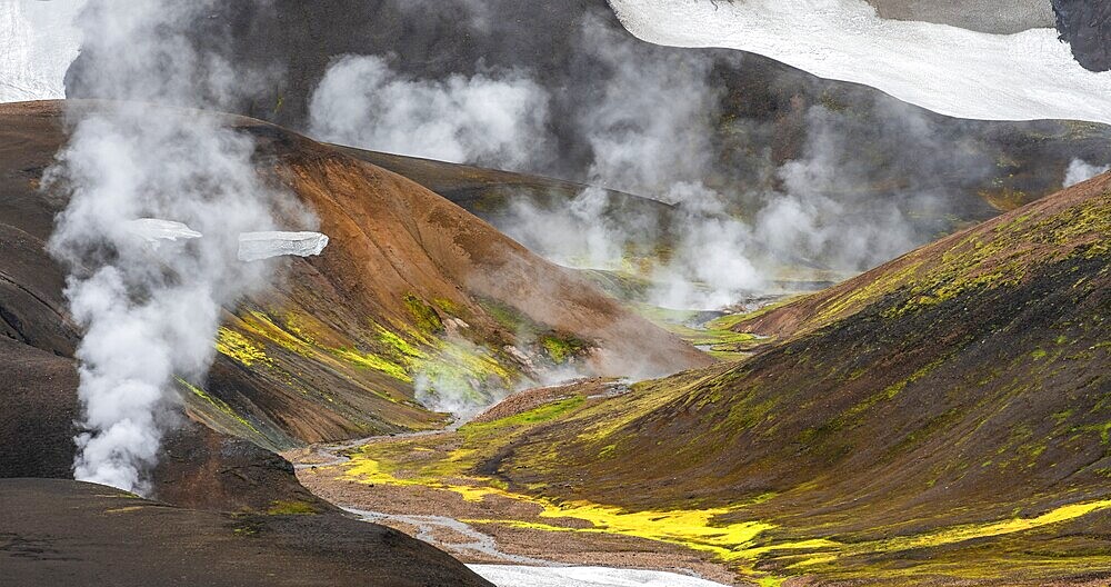 Colourful volcanic landscape with hills and snow, volcanic steaming hot springs, Laugavegur trekking trail, Landmannalaugar, Fjallabak Nature Reserve, Icelandic Highlands, Suðurland, Iceland, Europe