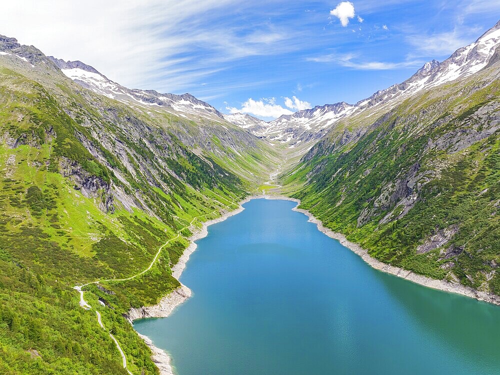 Blue lake, surrounded by high mountains and green, overgrown terrain under a bright blue sky, Klein Tibet, Zillertal, Austria, Europe