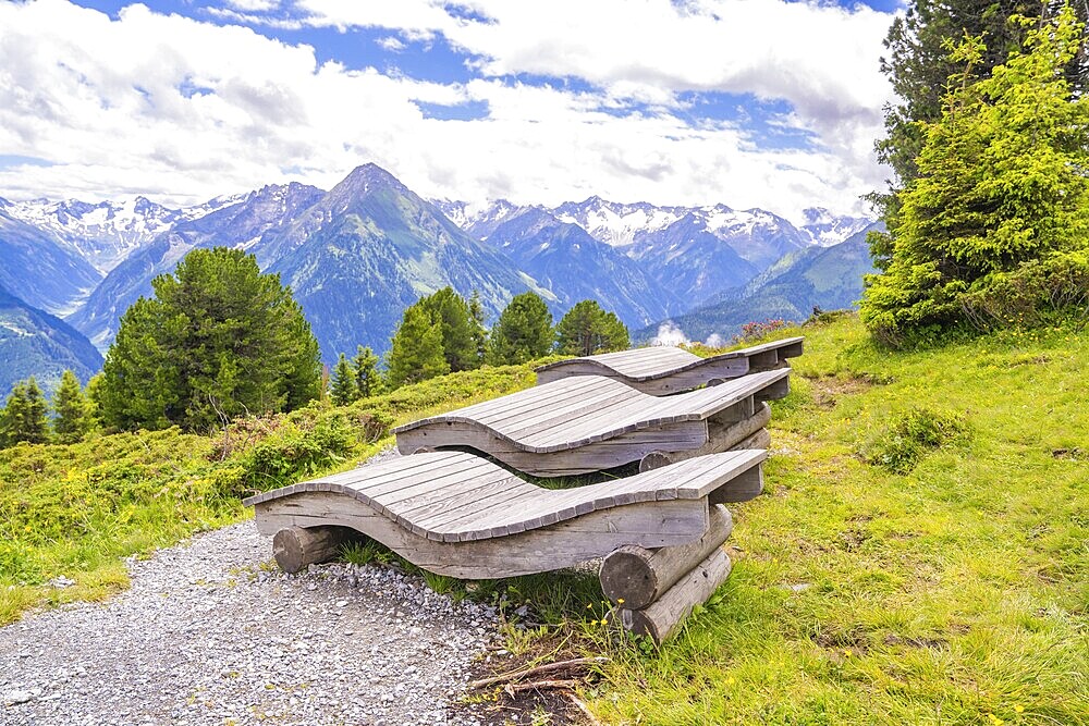 Wooden loungers on a mountain path offer a peaceful way to enjoy the surrounding landscape, Penken, Zillertal, Austria, Europe