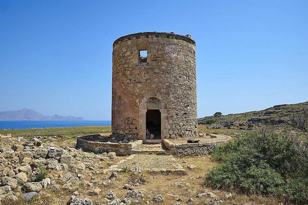 Old, abandoned mill near the coast, surrounded by rocky terrain under a blue sky, windmill, ruin, near Lindos, Lindos, Rhodes, Dodecanese, Greek Islands, Greece, Europe