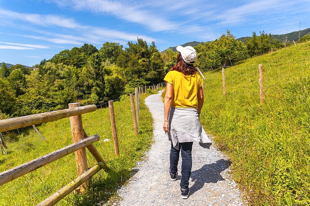 A woman walking on the path in the Jaizubia marsh in the town of Hondarribia or Fuenterrabia in Gipuzkoa. Basque Country