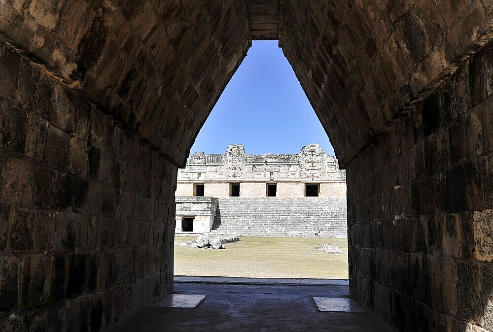 Unesco World Heritage Site, the Mayan ruins of Uxmal, Yucatan, Mexico, Central America, view through a stone tunnel to ancient ruins with open sky in the background, Central America