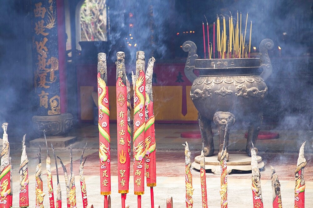 Chinese Temple filled with smoke from burning incenses. New Year's Eve. Ho Chi Minh, Vietnam, Asia