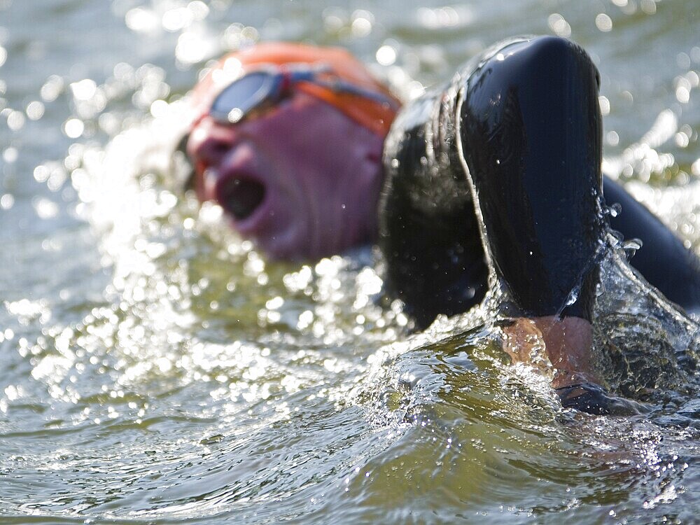 Closeup view of a triathlete during swimming on a contest