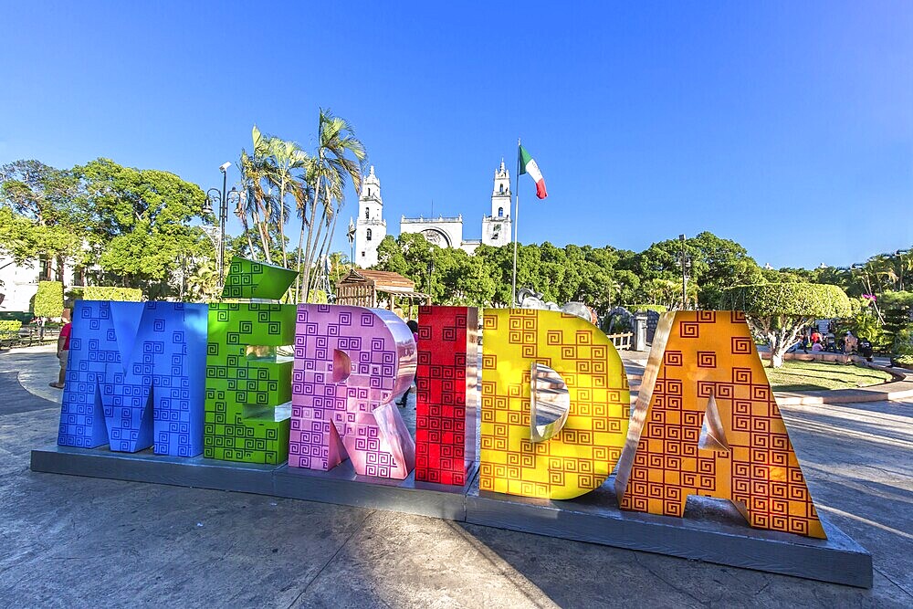 Big colorful letters representing Merida with an iconic Merida Cathedral at the background