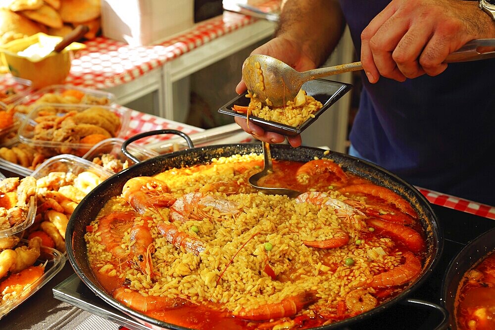 Paella preparation, street market stand near Barcelona Cathedral square