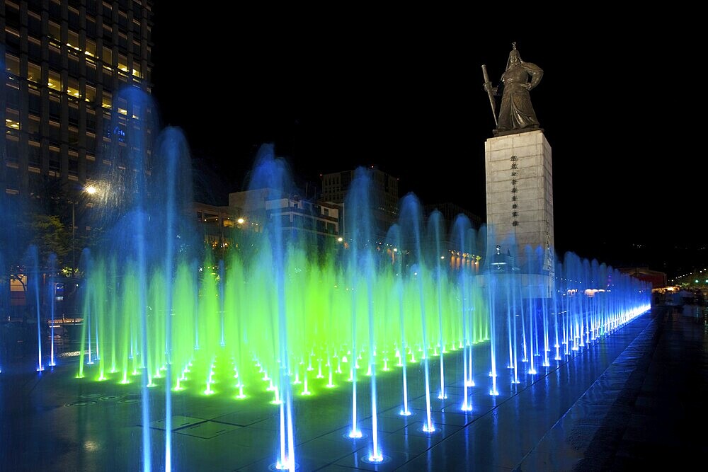 A beautifully colored fountain illuminates the Admiral Yi Sun-Sin statue in downtown Seoul, South Korea, Asia