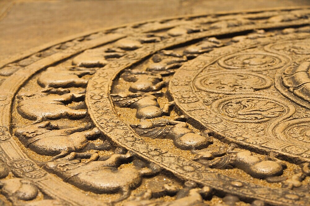 A ground carving at the entrance to the Vatadage is a moonstone relief depicting the cycle of sansara in the ruins of ancient capitol of Polonnaruwa, Sri Lanka. Side