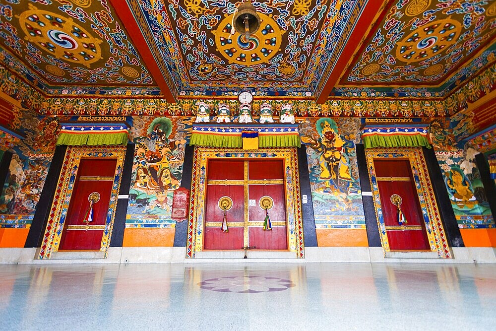 A low angle view of the beautifully painted doors and ceiling of the entrance to Rumtek monastery, the seat of the Karmapa located in Gangtok, Sikkim, India, Asia