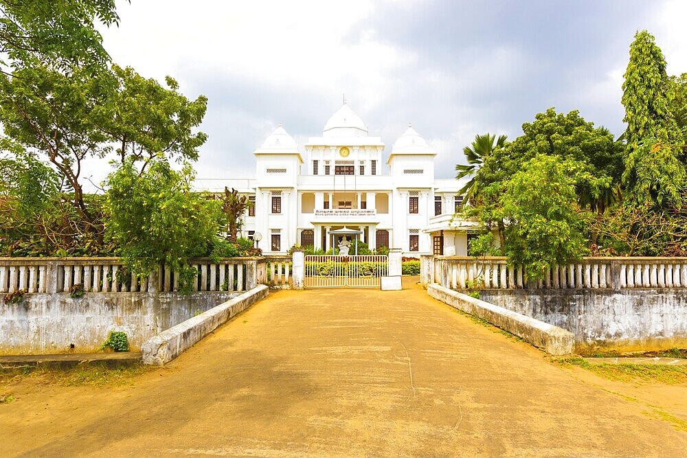 Driveway entrance to the Jaffna Public Library housed in a white British colonial building on a overcast day in Sri Lanka. Horizontal