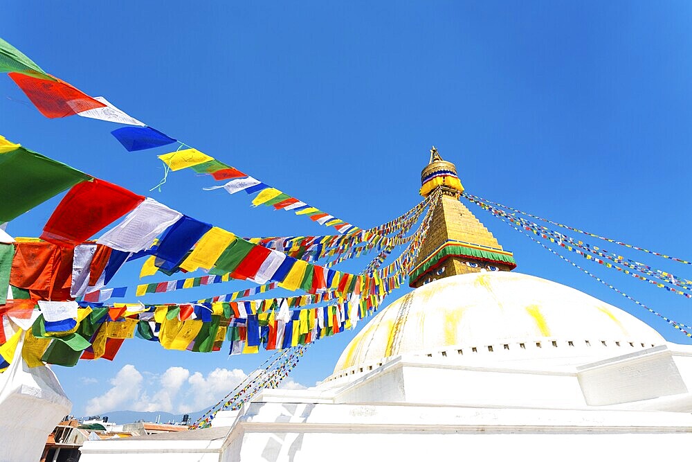 Prayer flags on white second level of Boudhanath Stupa in Kathmandu, Nepal on October 23, 2013. Horizontal