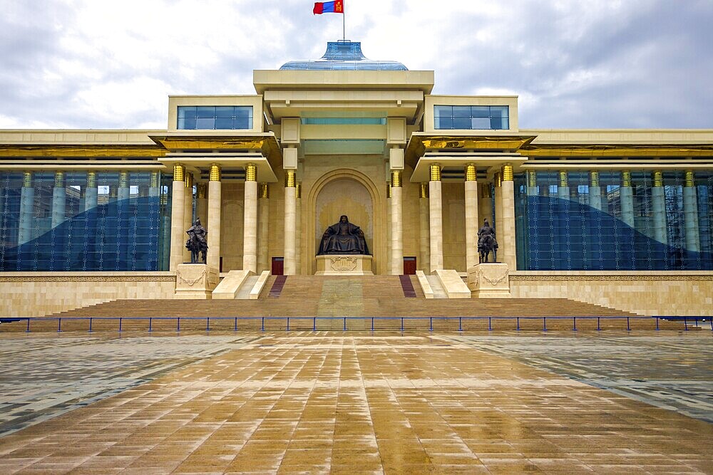 Ghengis Khan statue sits at the centre of the Government Palace building on a rainy wet day at Sukhbaatar Square in downtown Ulaanbaatar, Mongolia, Asia