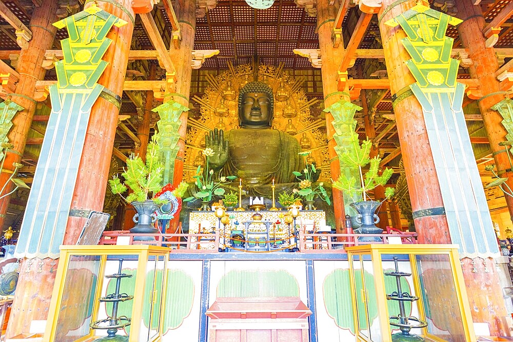 Front of the centred largest bronze Daibutsu statue and altar inside the Great Buddha Hall, Daibutsud-en, at Todai-ji temple in Nara, Japan. Horizontal interior