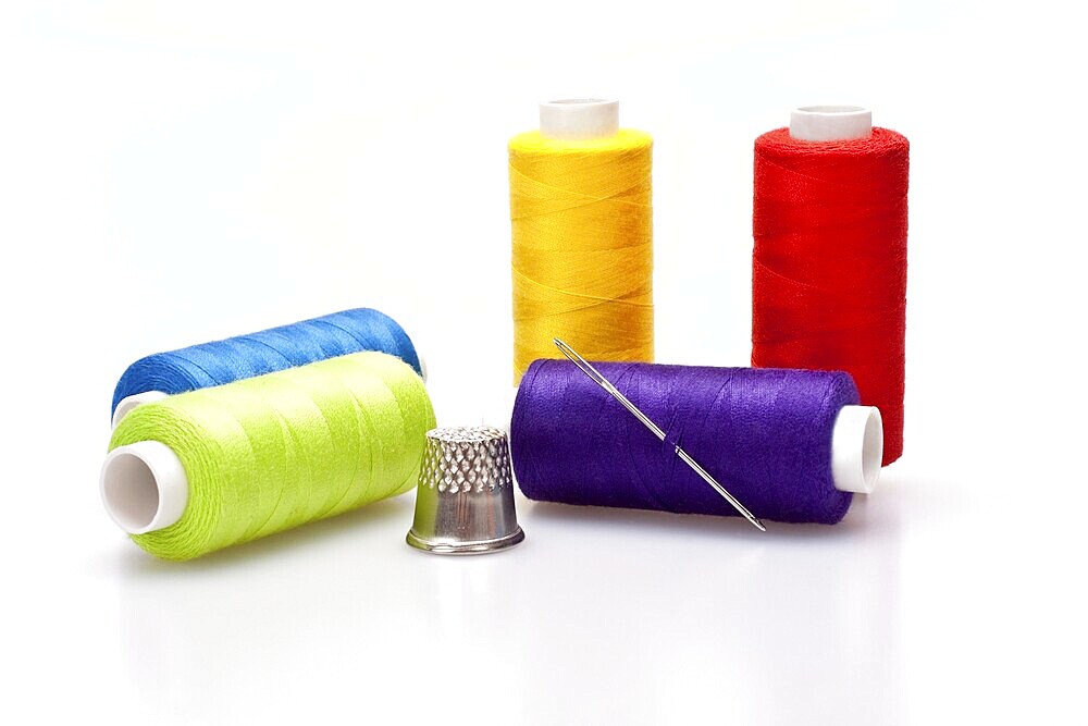 Multi-coloured rainbow threads for sewing with needle and thimble